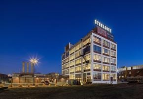 St Louis apartment for rent - a large building with a sign on top of it at night