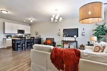Lake St. Louis townhouse for rent - a living room and kitchen with a couch and a rug