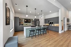 Dardenne Prairie apartment for rent - a kitchen and dining room with a counter and chairs at The Prairie Luxury Apartments, Dardenne Prairie Missouri