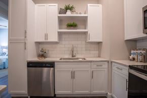Webster Groves apartment for rent - A kitchen with white cabinets and a stainless steel dishwasher at The Elle on Lockwood Apartments, Missouri, 63119
