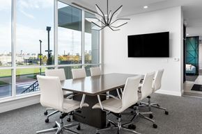 St Louis apartment for rent - a conference room with a large window and a table with white chairs at 2200 LaSalle Apartments, St Louis, 63104