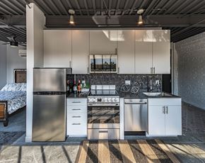 St Louis apartment for rent - a kitchen with white cabinets and stainless steel appliances