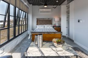 St Louis apartment for rent - a bedroom with a bed and a table with a bowl of fruit
