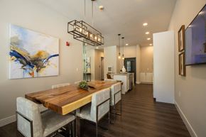 Webster Groves apartment for rent - A modern dining room with a wooden table and chairs at The Elle on Lockwood Apartments, Webster Groves, Missouri