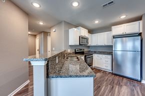 Sedalia apartment for rent - A kitchen with granite countertops and stainless steel appliances.