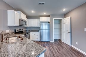 Sedalia apartment for rent - A kitchen with granite countertops and stainless steel appliances.