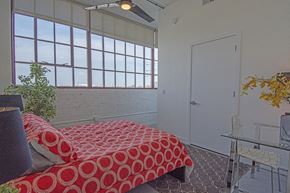 St Louis apartment for rent - a bedroom with a bed and a large window