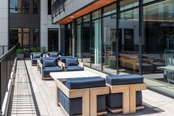 Outdoor terrace with lounge seating and wood canopy