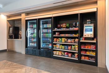 Market with refrigerated drinks and snack shelves