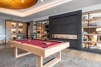 Game room with pool table and modern fireplace