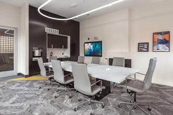 Conference room with marble table and modern lighting