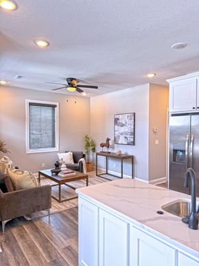 Sedalia apartment for rent - A modern kitchen with a brown sofa and a ceiling fan.