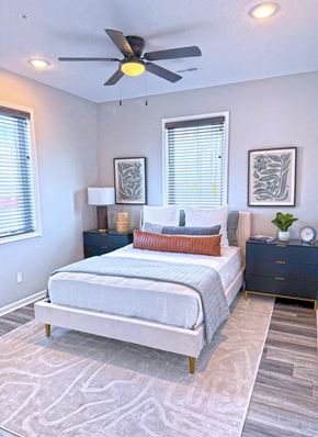 Sedalia apartment for rent - A bedroom with a bed, nightstand, and two framed pictures on the wall.