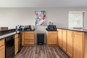 Lake St Louis apartment for rent - a kitchen with wooden cabinets and a counter top with a sink and a microwave