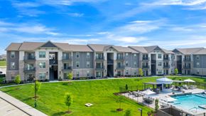 Dardenne Prairie apartment for rent - an apartment complex with a pool and grassy area
