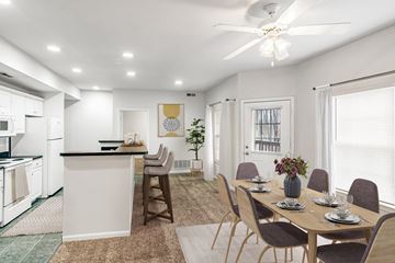 Kansas City apartment for rent - A modern kitchen with a dining table set for four.