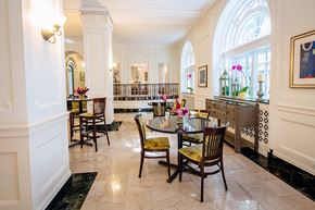 Saint Louis apartment for rent - dining area with dark tables and green dining chairs at Residences at Forest Park, Missouri