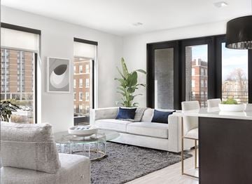 St Louis apartment for rent - a living room with a white couch and a table