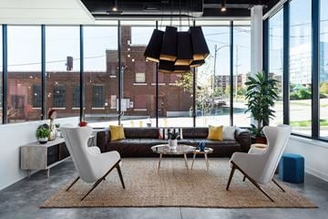 St. Louis apartment for rent - a living room with a couch and chairs and a large window