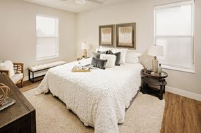 Valley Park apartment for rent - a bedroom with a large bed and two windows at 44 West Luxury Living, Valley Park, MO, 63088