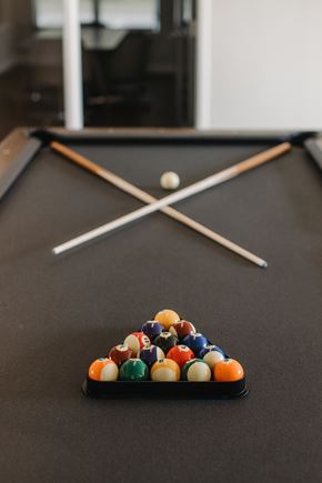 Valley Park apartment for rent - a pool table with billiard balls and sticks at 44 West Luxury Living, Missouri, 63088