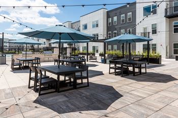 Outdoor patio with dining tables and blue umbrellas