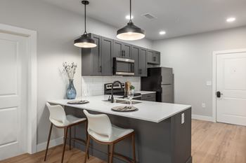Modern kitchen with island seating and pendant lighting