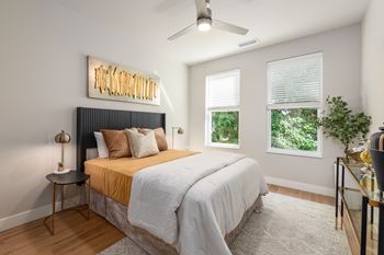 Bedroom with ceiling fan and two windows