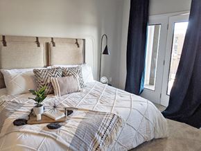 Granger apartment for rent - Cozy bedroom with upholstered headboard and bedding at GrandView Flats and Townhomes Apartments, Granger, IN 46530