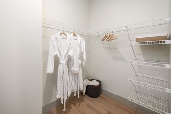Walkin closet with wire shelving and robes