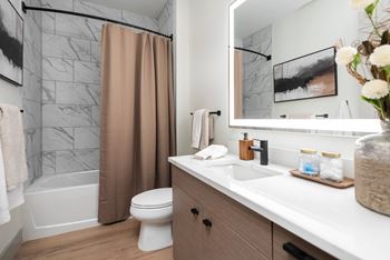 Modern bathroom with marble tiled shower and vanity