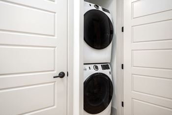 Stacked washer and dryer in laundry closet