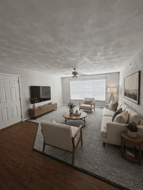 Mascoutah apartment for rent - A living room with a white sofa, a wooden coffee table, and a TV on the wall.