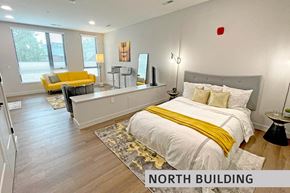 St. Louis apartment for rent - a bedroom with a bed and a couch  at Expo at Forest Park, St. Louis, MO