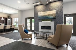 Saint Louis apartment for rent - A modern living room with a fireplace and two chairs.