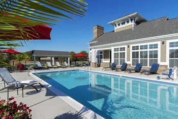 A swimming pool in front of a house