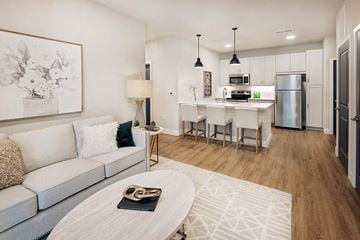 Dardenne Prairie apartment for rent - A modern living room with a grey couch and a coffee table.