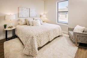 Dardenne Prairie apartment for rent - The Prairie model apartment bedroom with light carpet, bed and window