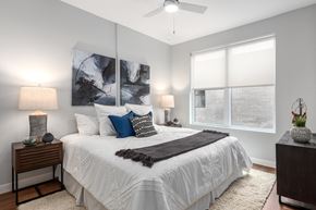 Chesterfield apartment for rent - A bedroom with a large bed, two lamps, and a painting on the wall.