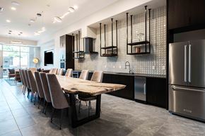 Carmel apartment for rent - A modern kitchen with a long table and chairs.