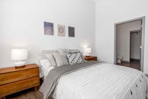 Carmel apartment for rent - A bedroom with a large bed and two lamps on side tables.