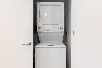 An empty laundry room with a washer and dryer