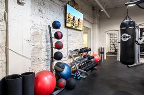 Saint Louis apartment for rent - A gym with a punching bag, weights and exercise balls. at York House, Missouri, 63108