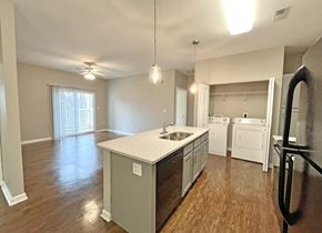 Swansea apartment for rent - A kitchen with a white countertop and wooden floors.