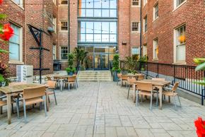Saint Louis apartment for rent - York House quaint courtyard with communal seating and grilling station at York House, Saint Louis, MO 63108