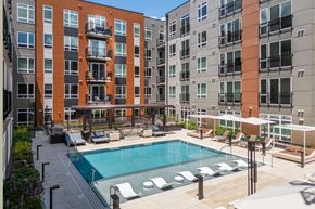 Clayton apartment for rent - Courtyard pool with lounge chairs and seating areas at Bemiston Place Apartments, Clayton, Missouri
