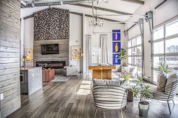 A living room with furniture and a large fireplace