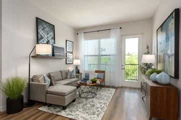 Saint Charles apartment for rent - Modern living room with a couch coffee table, large window a door leading to a balcony