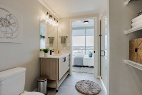 St. Louis apartment for rent - a bathroom with a toilet and a sink and a door to a bedroom at One Foundry Way, St. Louis, MO