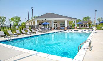 Our apartments have a swimming pool with a clubhouse in the background